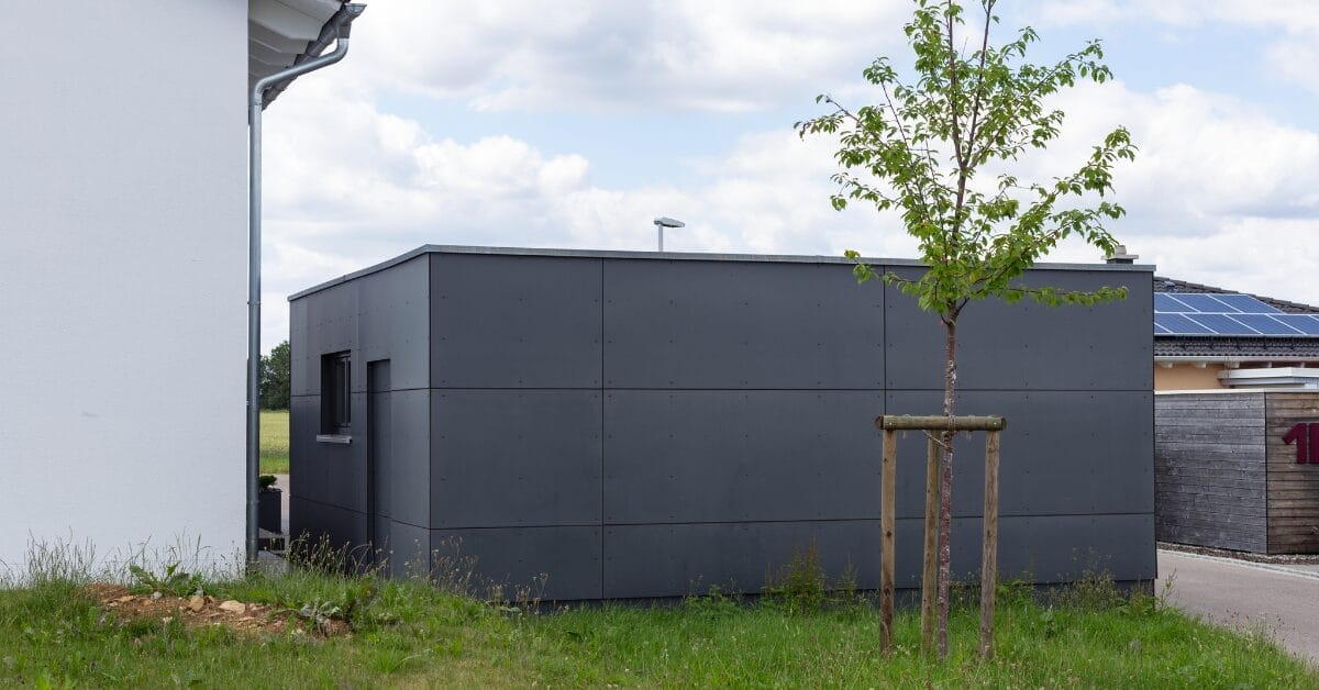 Sleek new metal shed garage in suburban neighborhood