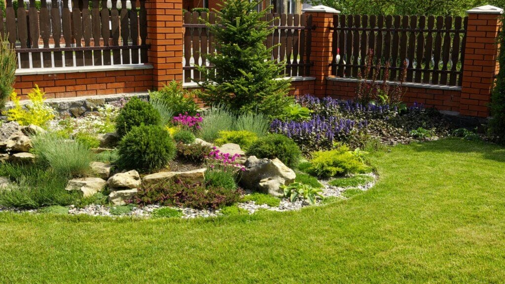 Gardens adorned with river rocks and flowers.