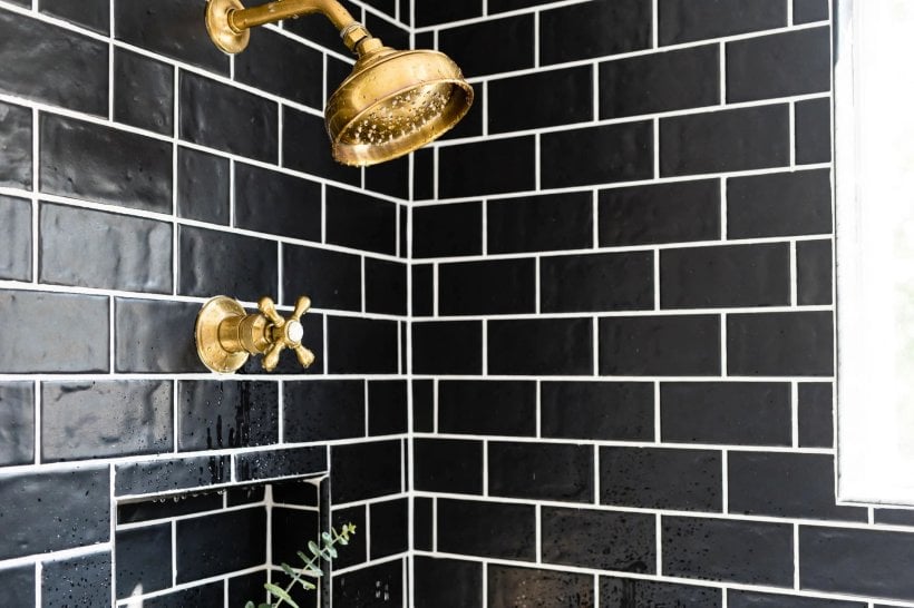 black tile bathroom: dark shower zone balanced by pale walls and floor