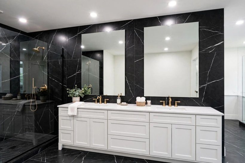 black tile bathroom: walk-in shower with glass screen and tiled niche