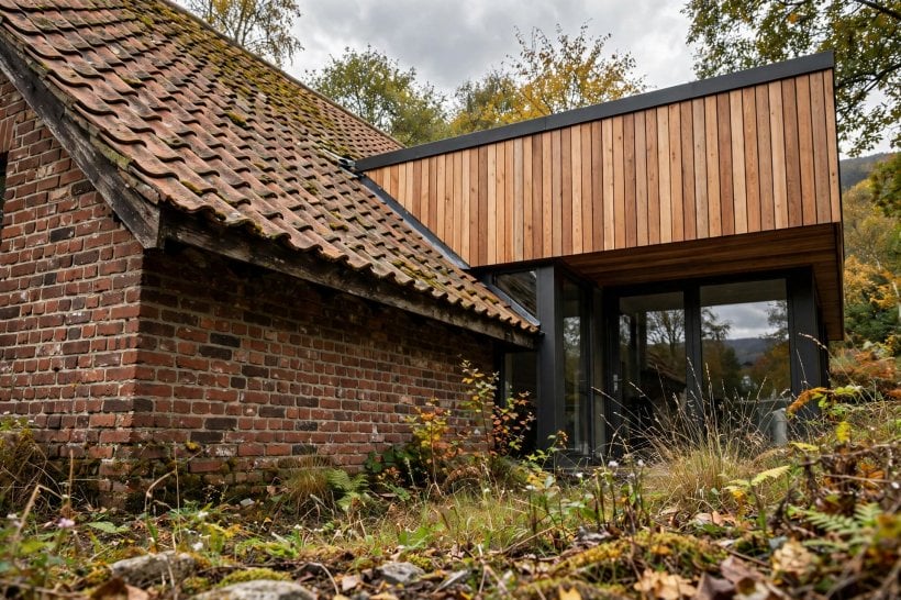 1950s brick house modern addition: open kitchen-diner with an island and dining table near the garden doors