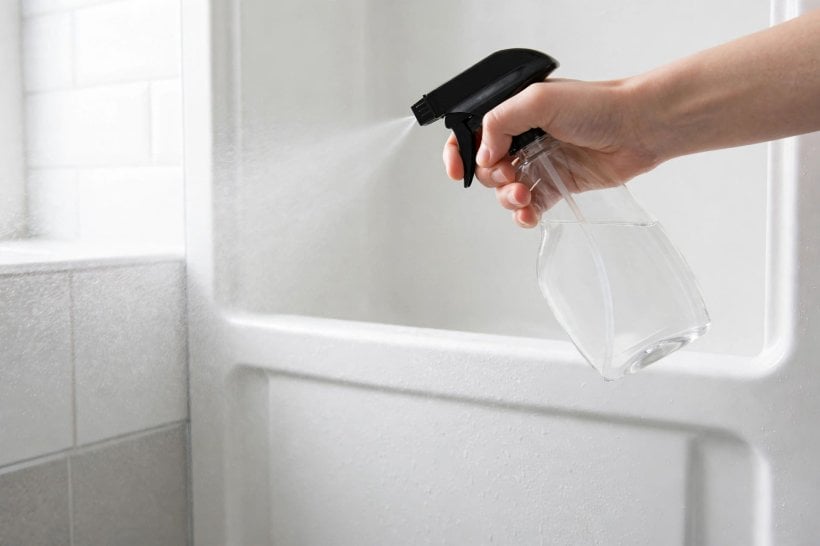 how to clean plastic shower surround: washing a panel from the top down with a soft cloth