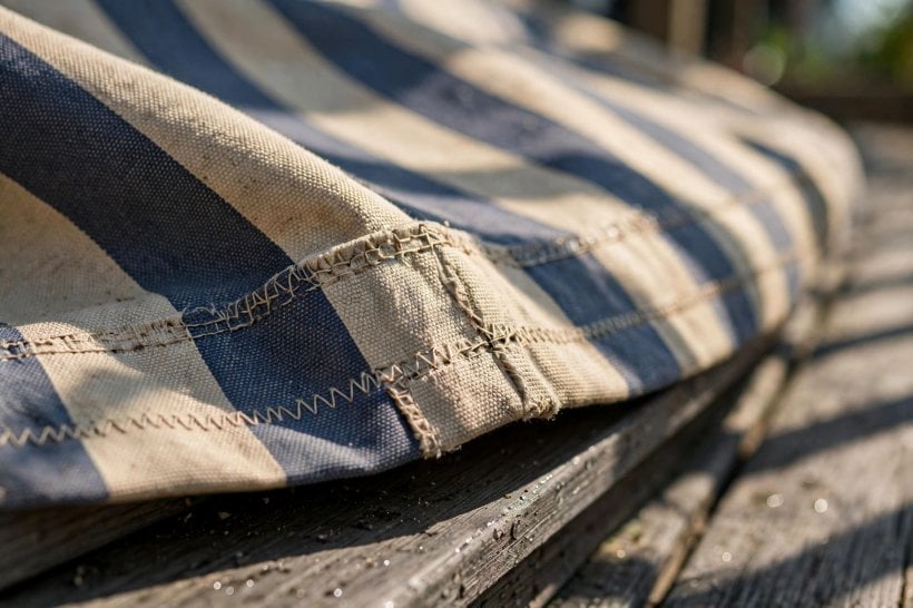 deck awnings ideas: a striped awning and cushions giving a deck a room-like feel