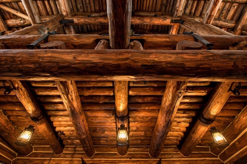 log cabin inside: leather sofa and solid wood furniture by the fire