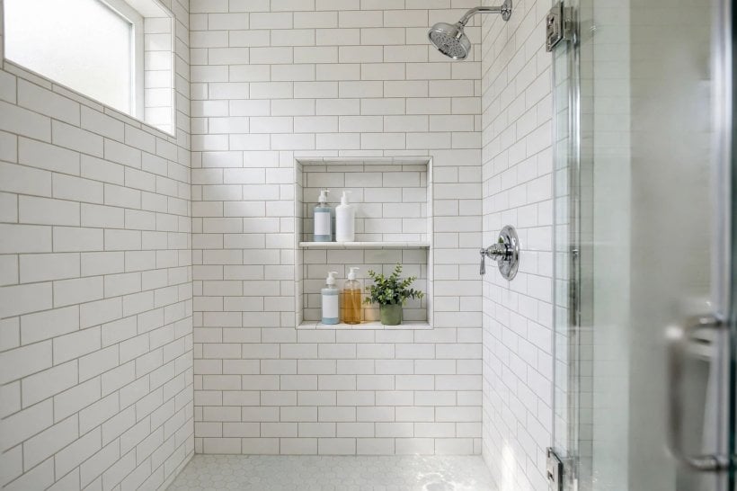 shower shelf ideas: tall tension pole caddy with tiered baskets in a shower corner