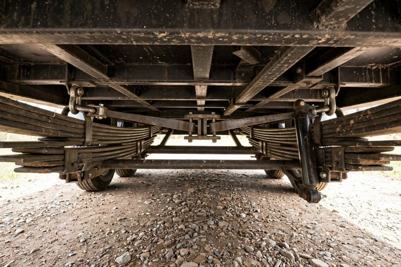 how to choose trailer axles for a tiny house: leaf springs and the equalizer bar between tandem spring hangers