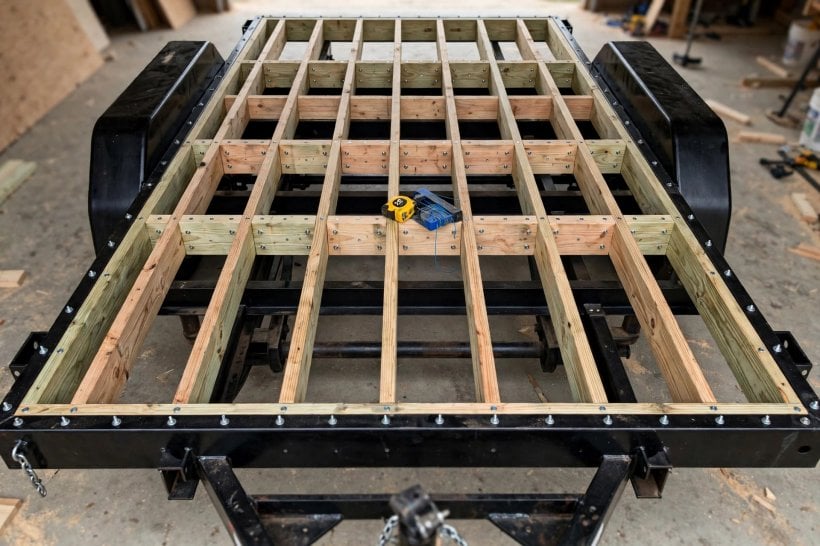 Fasten Subfloor to a Steel Trailer: the hybrid pattern of perimeter bolts and interior screws on the floor frame