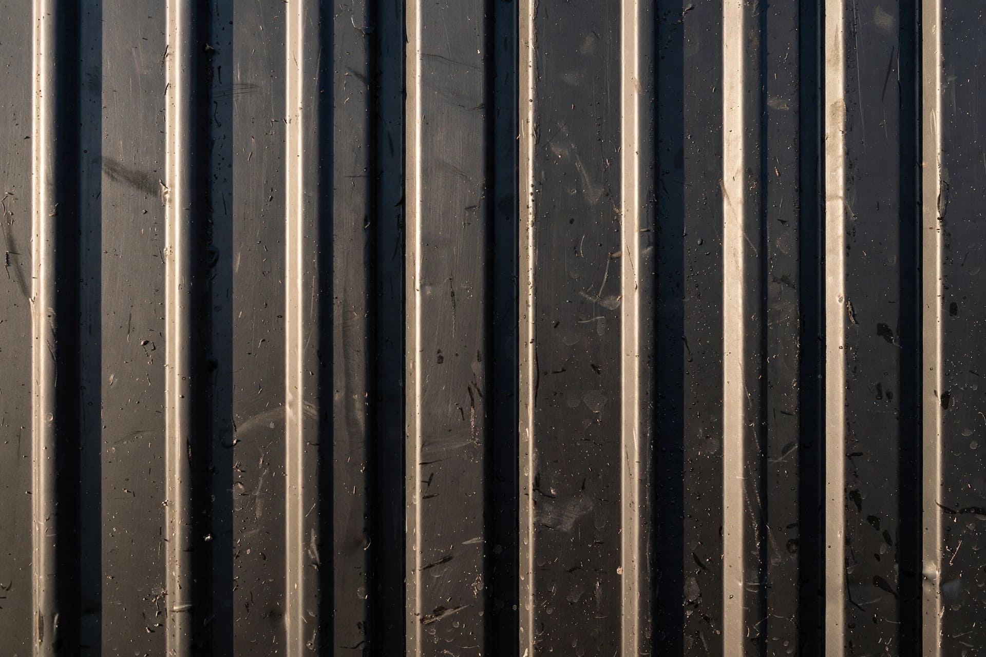 metal siding oil canning: striated panel texture that breaks up reflections
