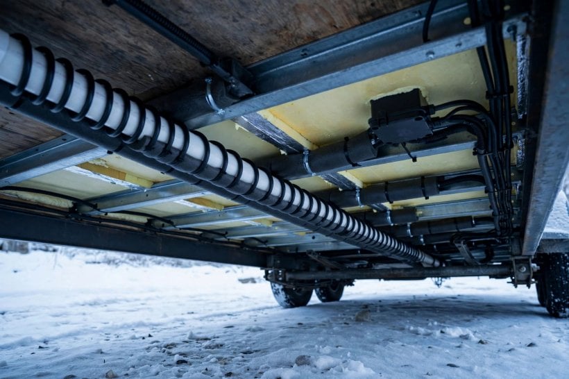 heating a tiny home in winter: heat-traced and insulated water pipes beneath a tiny house floor