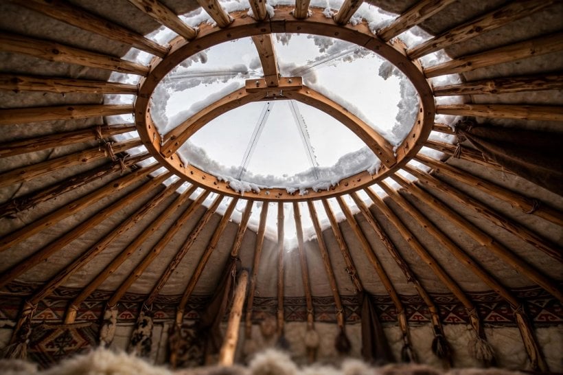 how to live in a yurt in winter: looking up at the toono roof ring and clear dome skylight