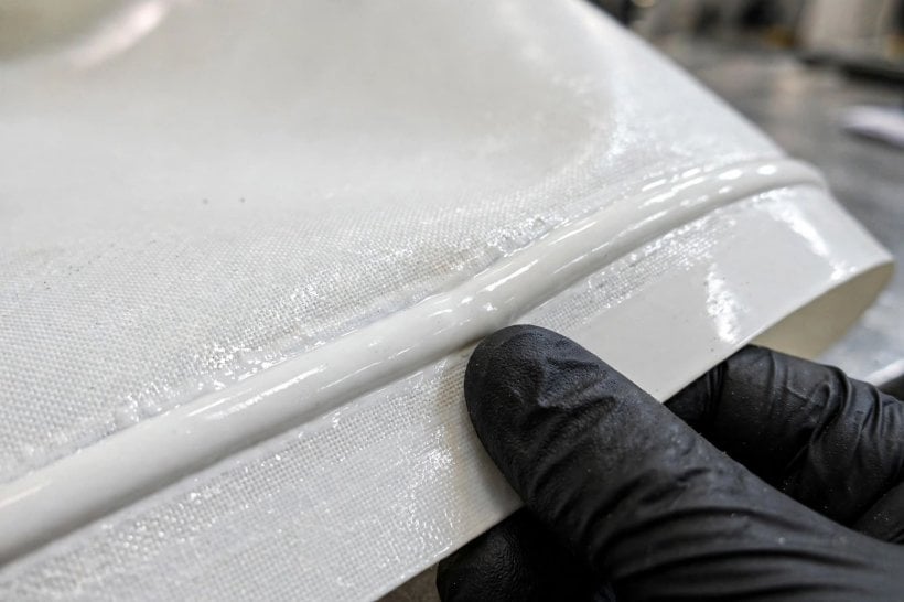 Inflatable House Structural Engineering: welded PVC-coated polyester membrane fabric being inspected up close