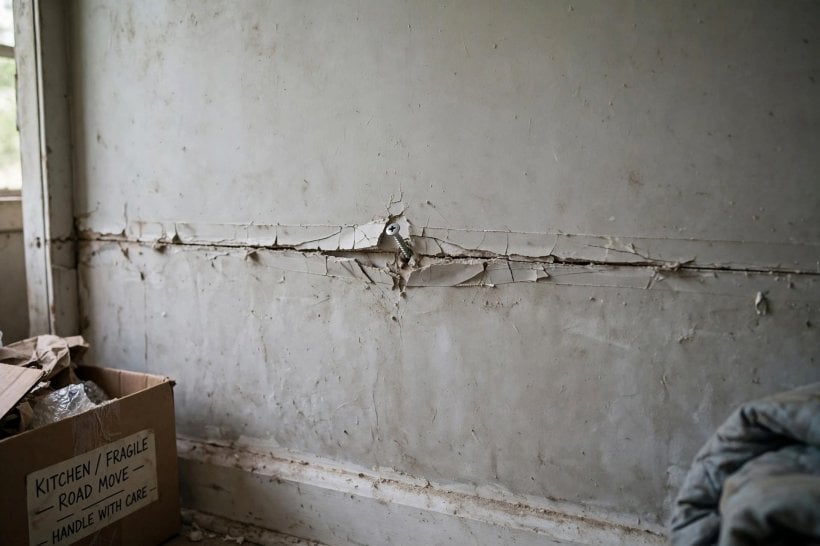 Lightweight Interior Wall Finishes for Tiny Houses: a cracked taped drywall seam and popped screw after a long tow