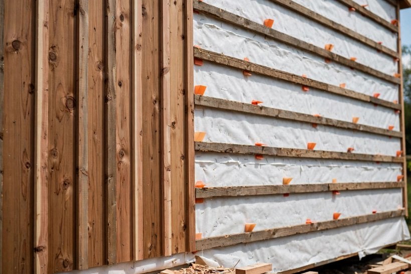 rain screen installation: horizontal furring strips with drainage shims under vertical board-and-batten siding