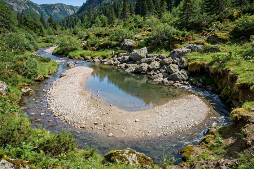 River Rock Dry Creek Bed: a natural creek bend with a wide pool, gravel bar and boulders clustered at the outside of the curve