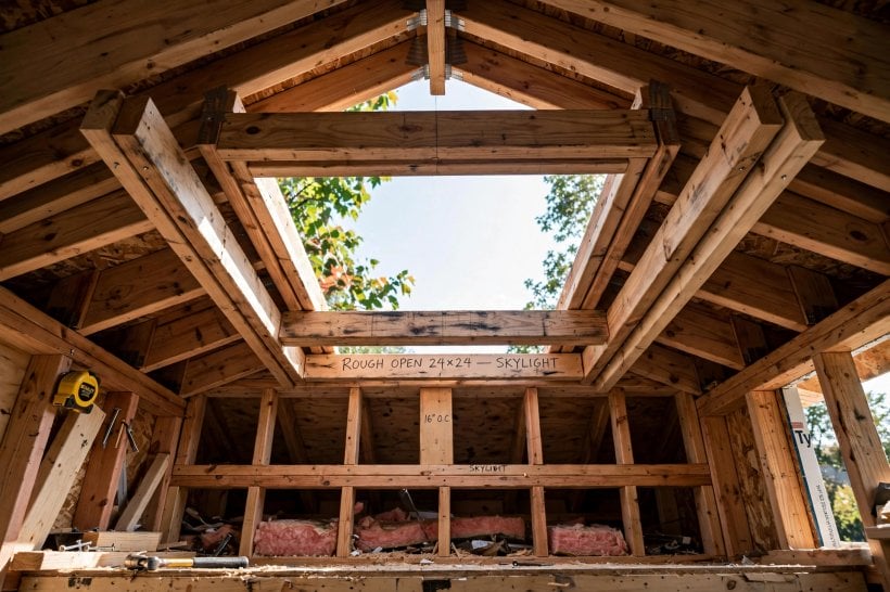 roof hatch installation: doubled headers and sistered trimmers framing a rough opening