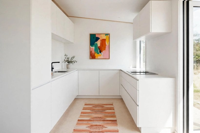 Scandinavian tiny house floor plans: all-white gallery kitchen with pale birch plywood floor