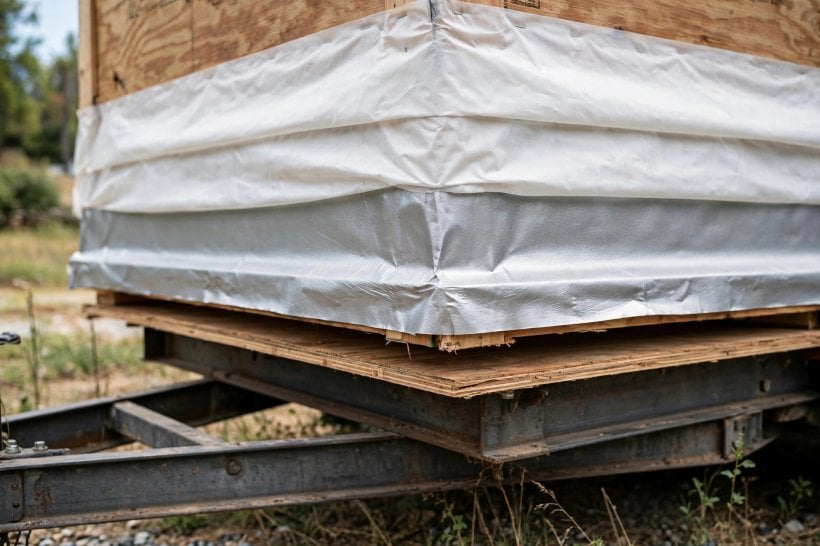 how to seal tiny house sill plates: flashing lapping from the sheathing down over the sill and subfloor edge