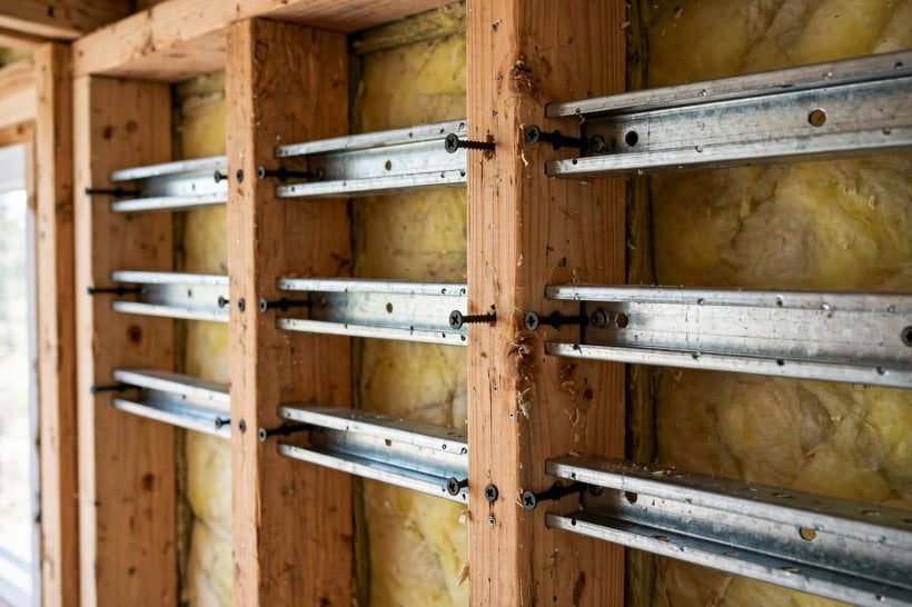 tiny house soundproofing: resilient channel strips screwed across wooden wall studs
