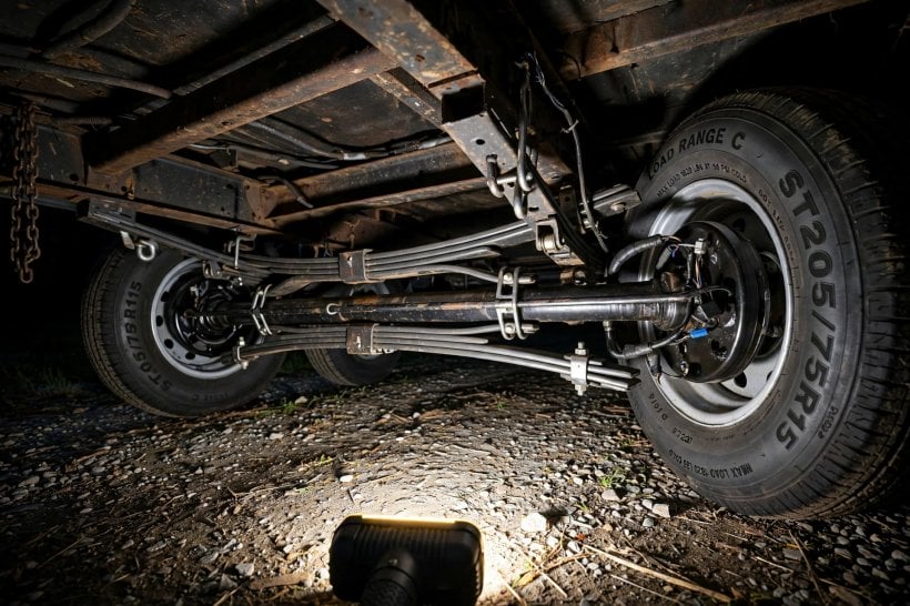 tiny house trailer buying guide: inspecting a tandem axle, electric brake drum and trailer tire