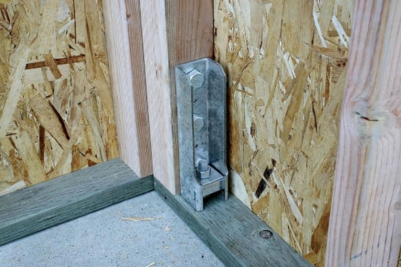 tiny house wind load shear calculator: hold-down bracket anchoring a shear wall at its base