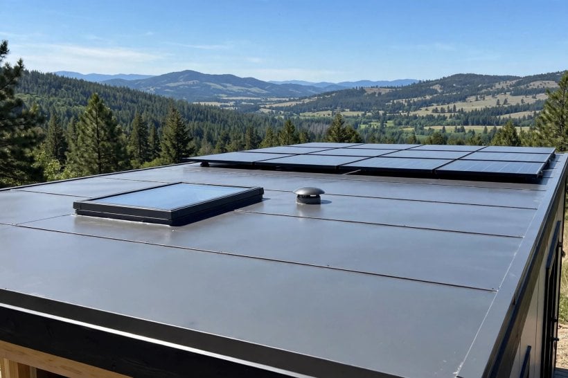 tiny house wind resistance: a clean flat tiny house roof with flush skylight and panels laid flat