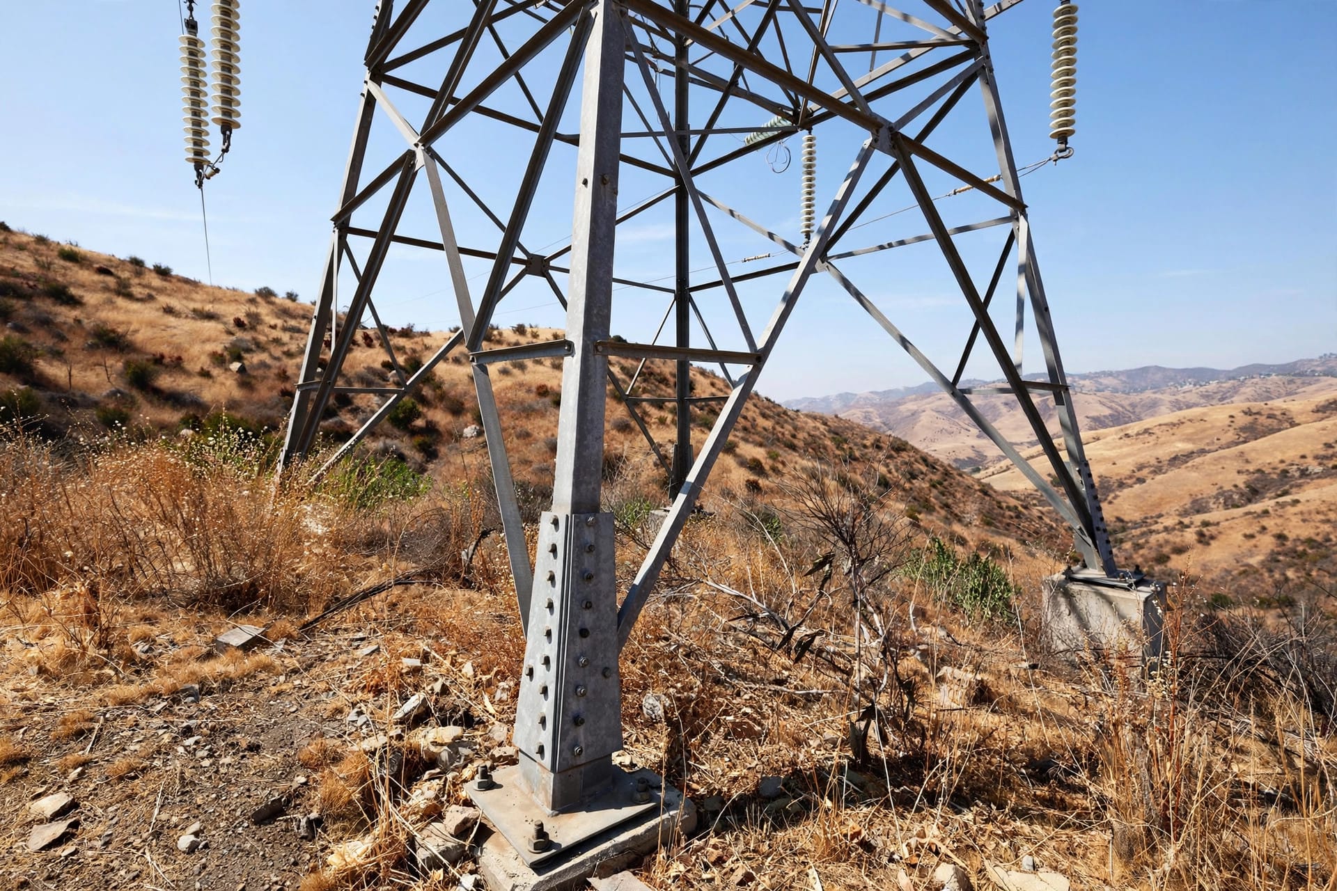 utility CEO responds to controversy over Eaton Fire: the base of a transmission tower in dry foothill brush