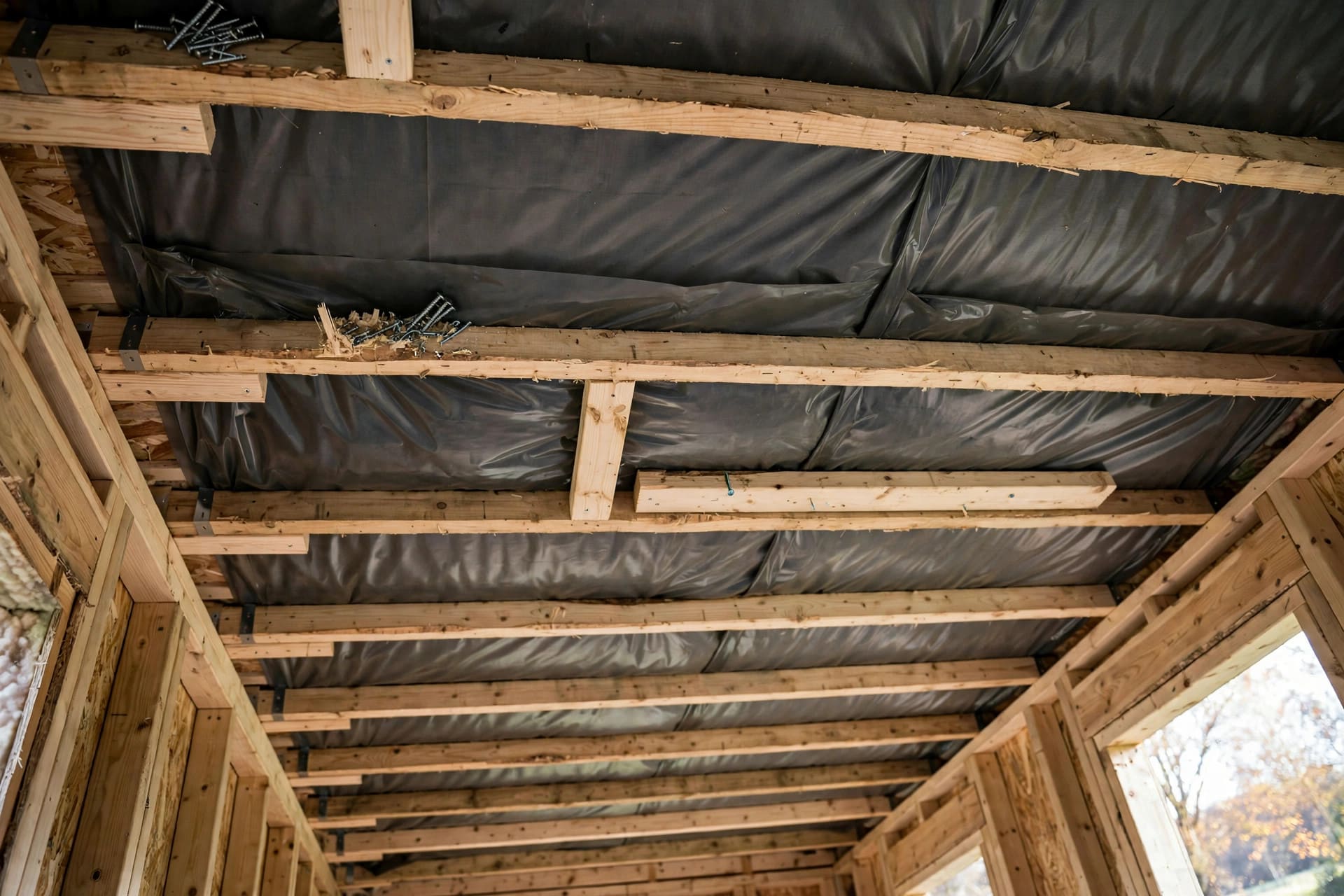vapor barrier placement guide: ceiling membrane held with battens before lining