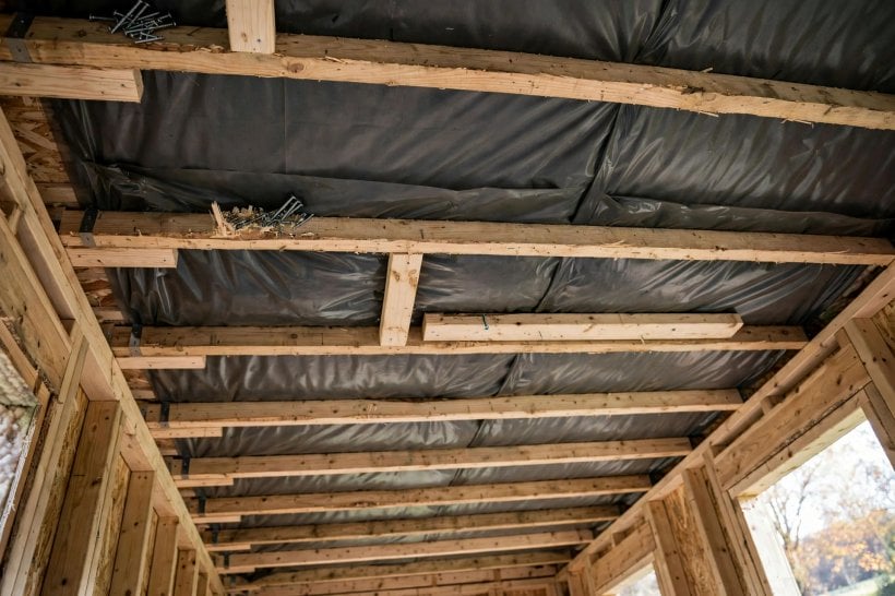 vapor barrier placement guide: ceiling membrane held with battens before lining